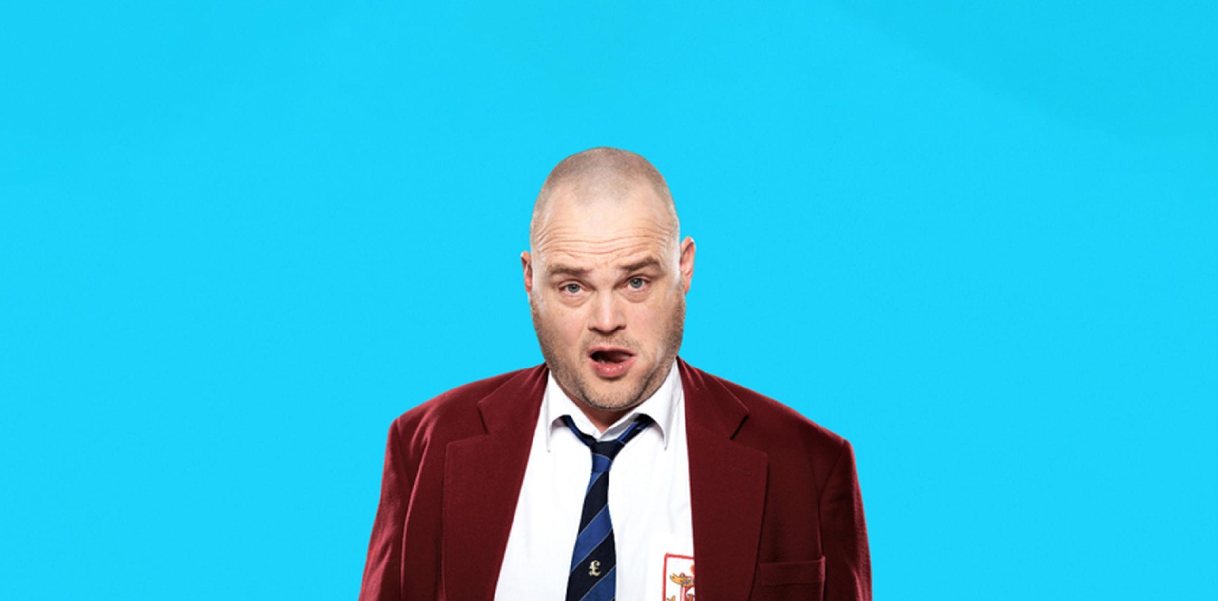 Man in red blazer, white shirt and loose tie against blue background