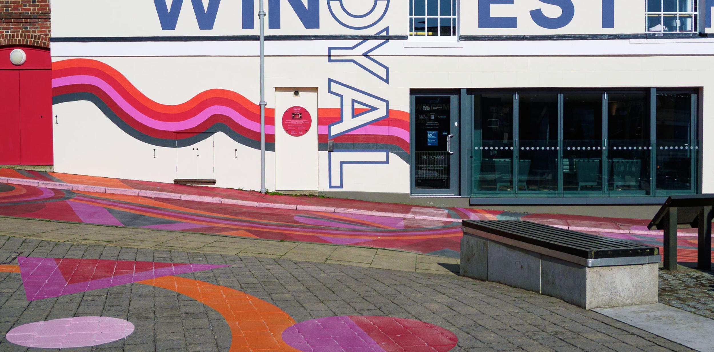 Colourful artwork on the street outside Theatre Royal Winchester
