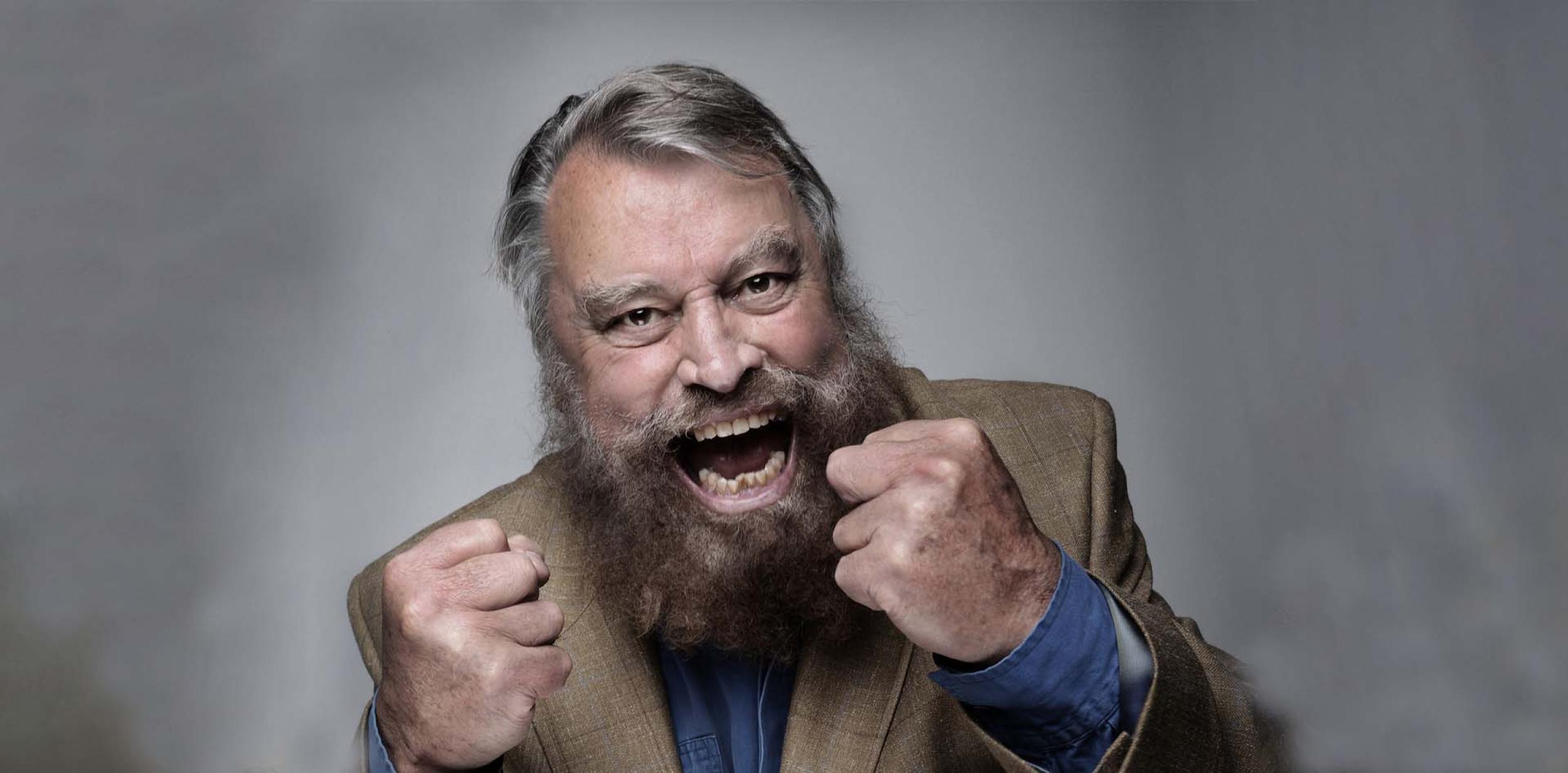 Brian Blessed with full beard and fists clenched