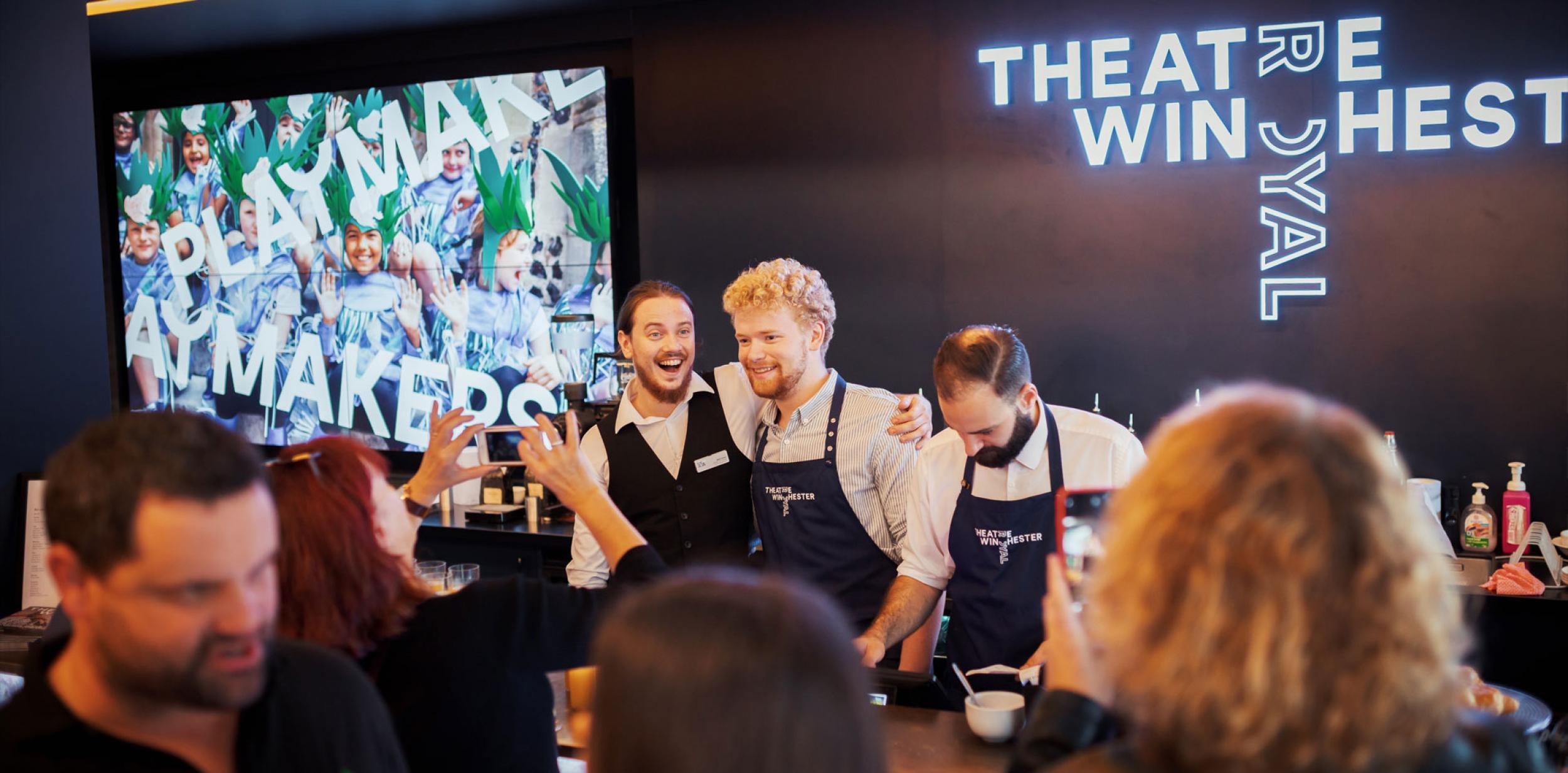 Smiling people working in a cafe.