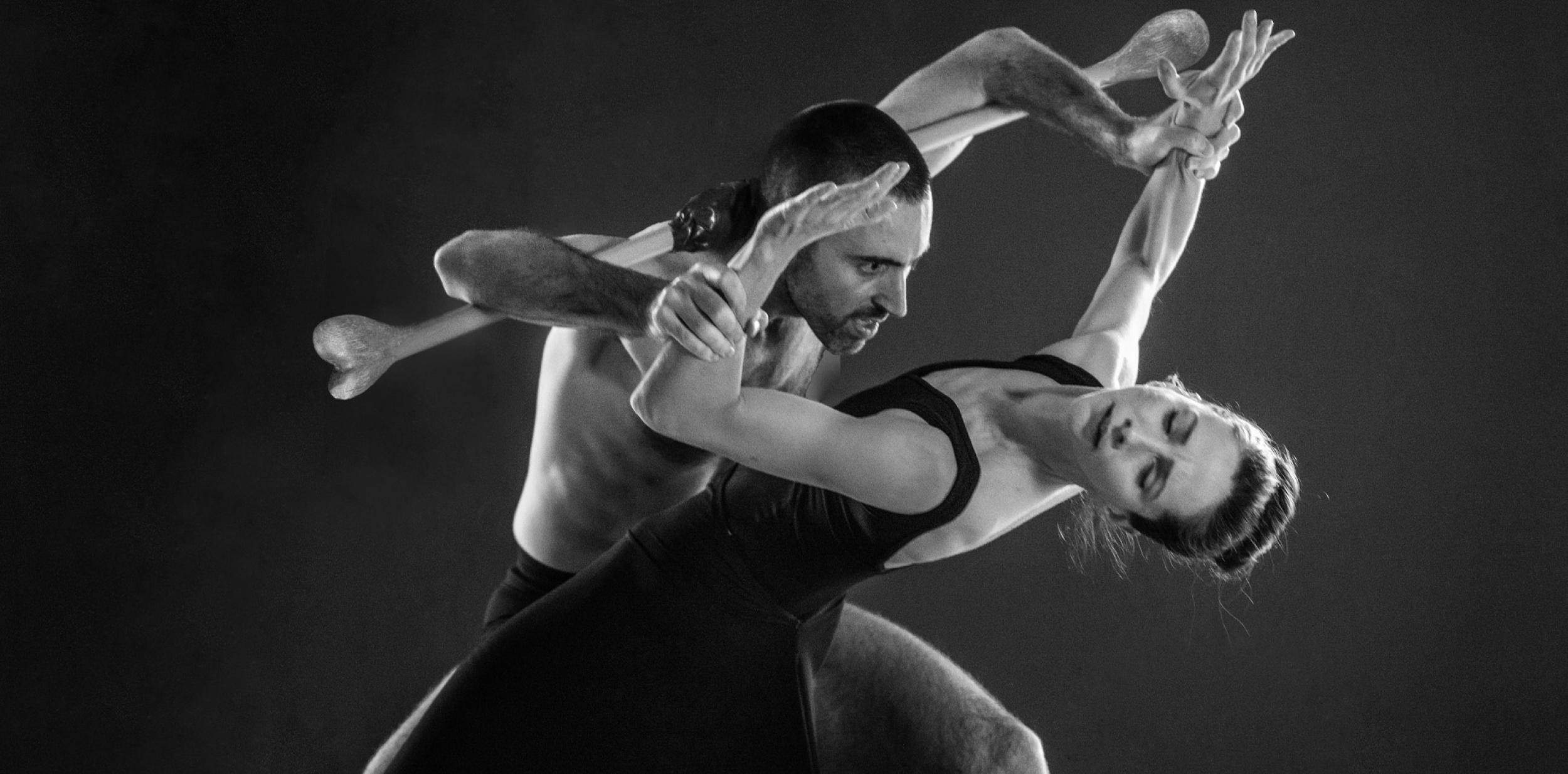 Black and white photo of a male and female couple contemporary dancers in hold