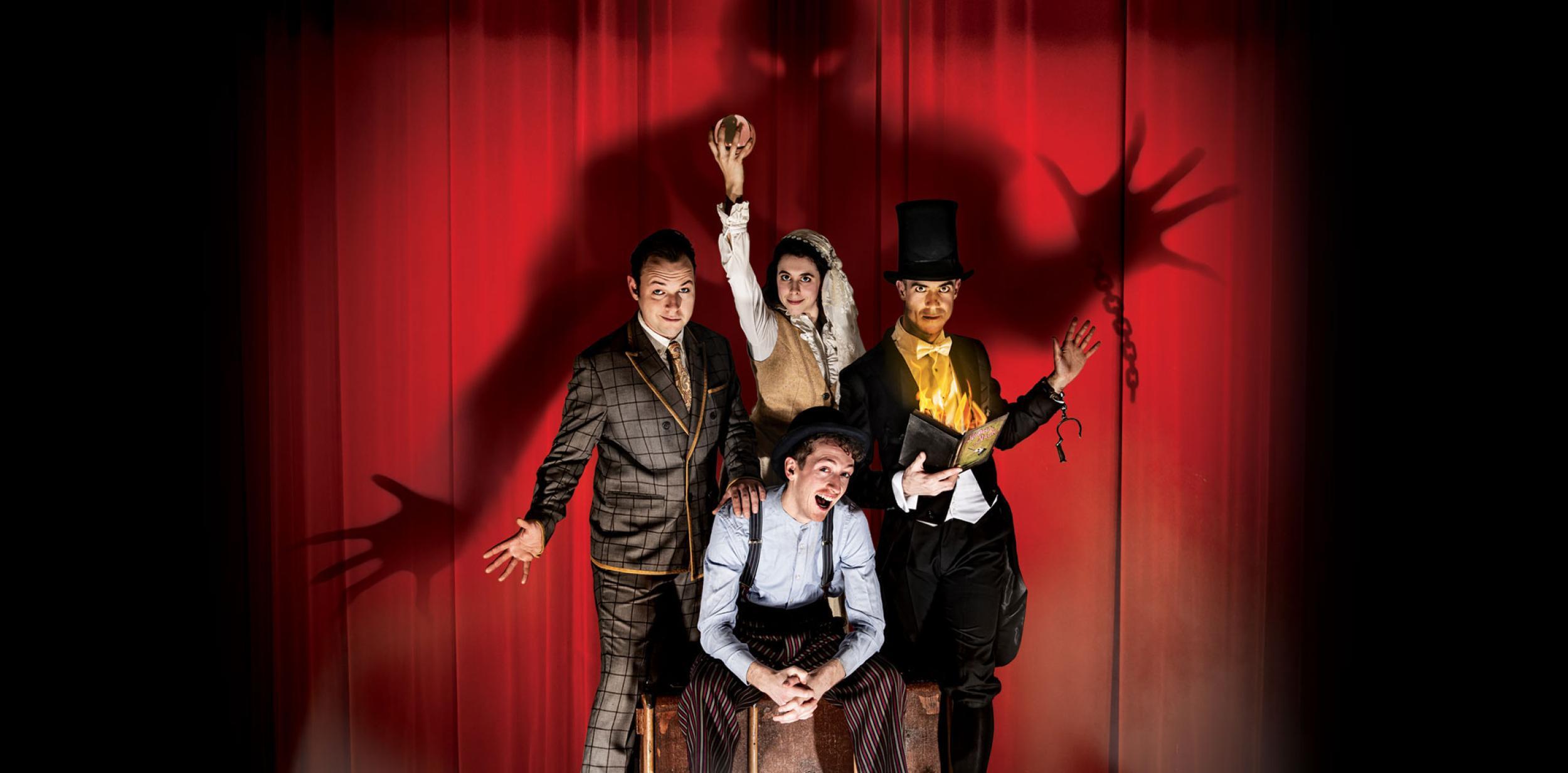 Four actors in front of a red curtain