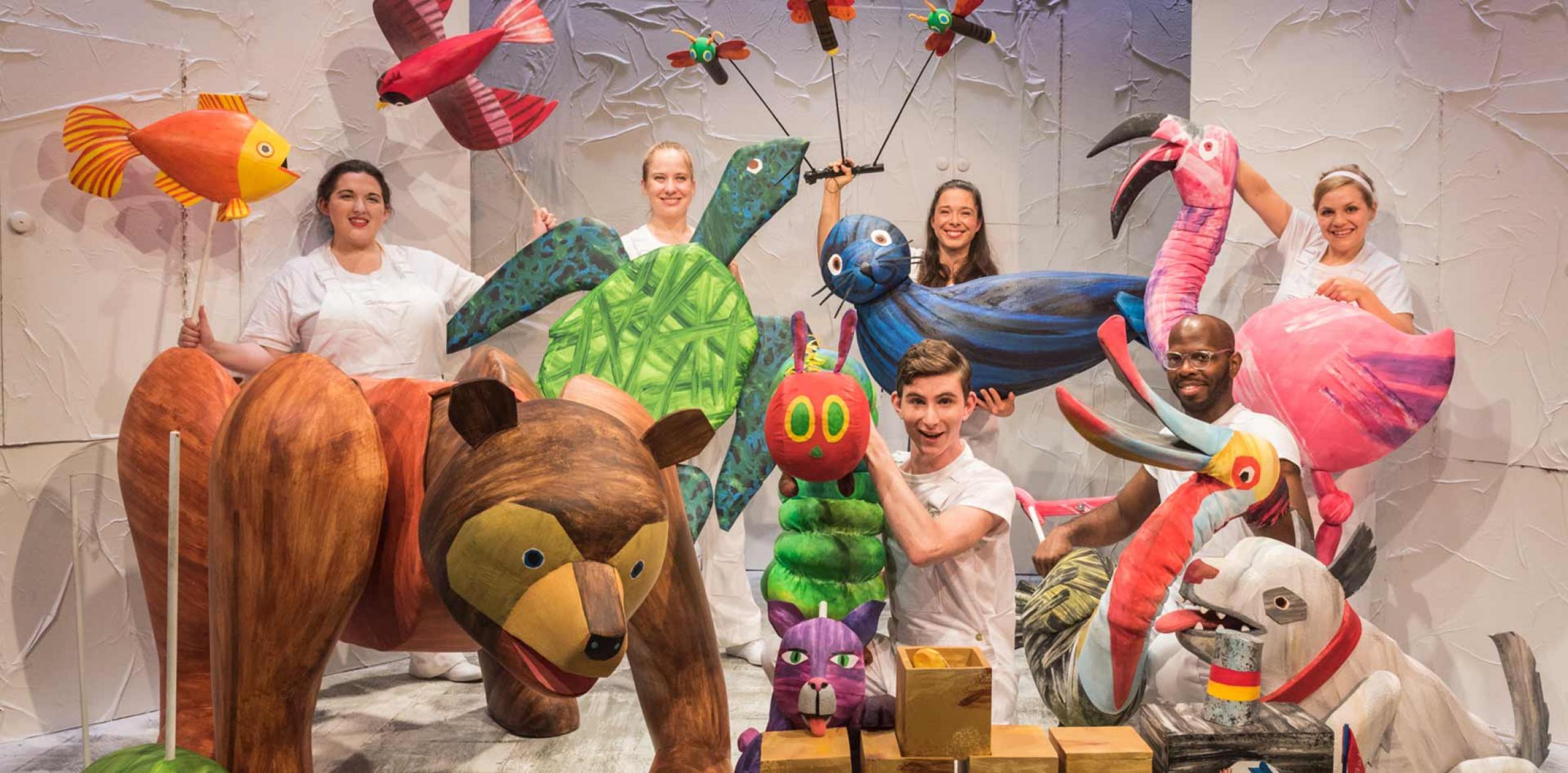 Cast of animal puppets and puppeteers