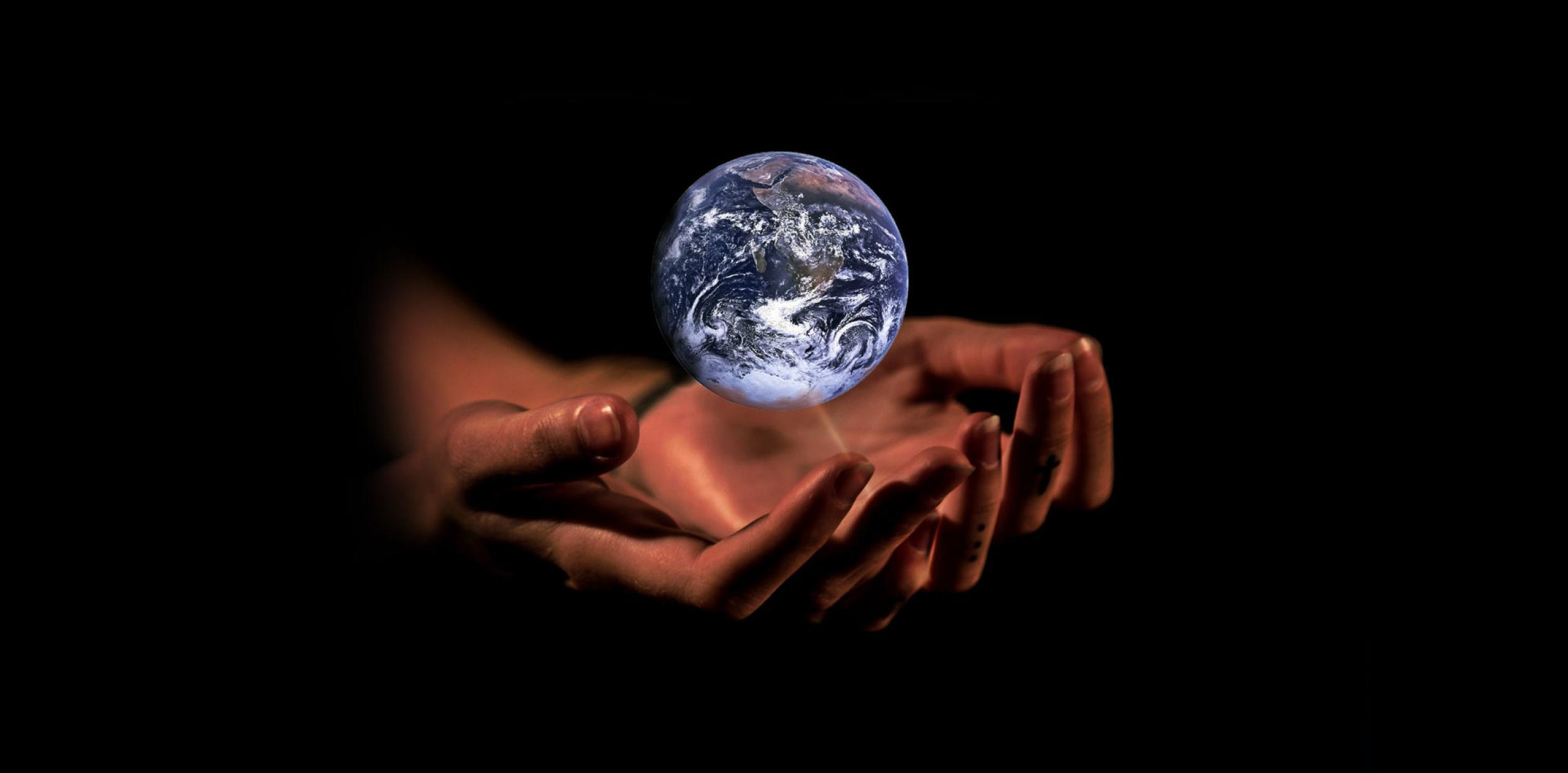 Pait of hands holding up planet Earth