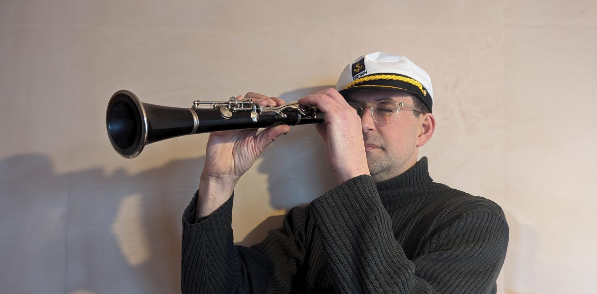 A person using a clarinet as a telescope