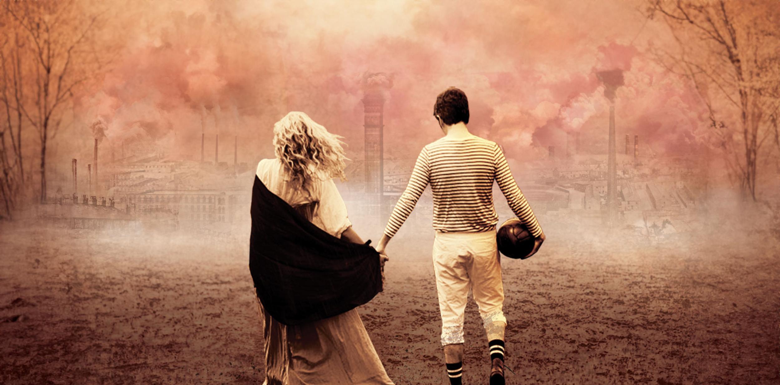 Two people holding hands and walking towards an industrial city