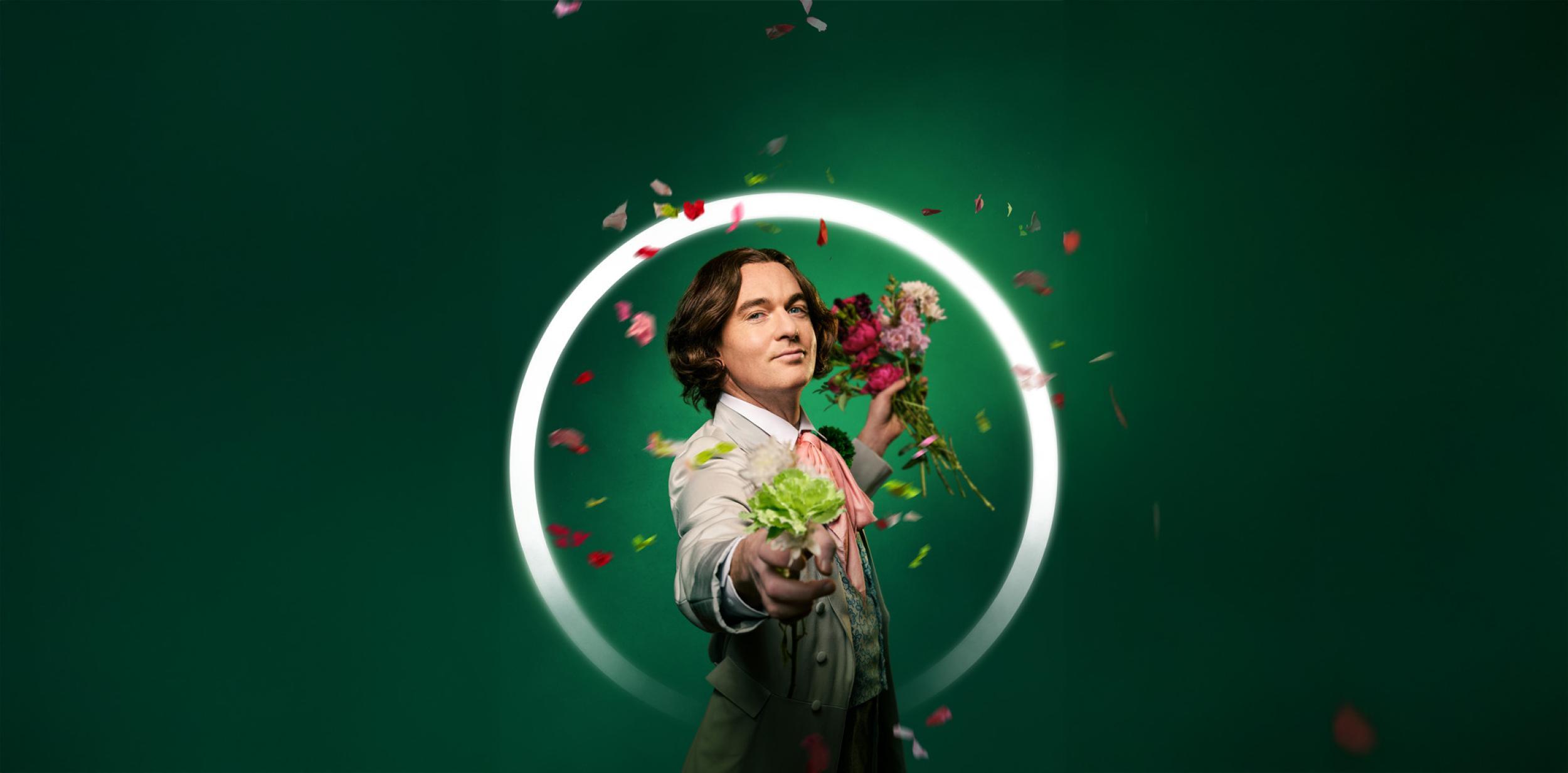 Oscar Wilde character holding out his hand and petals floating around him, with a green background.