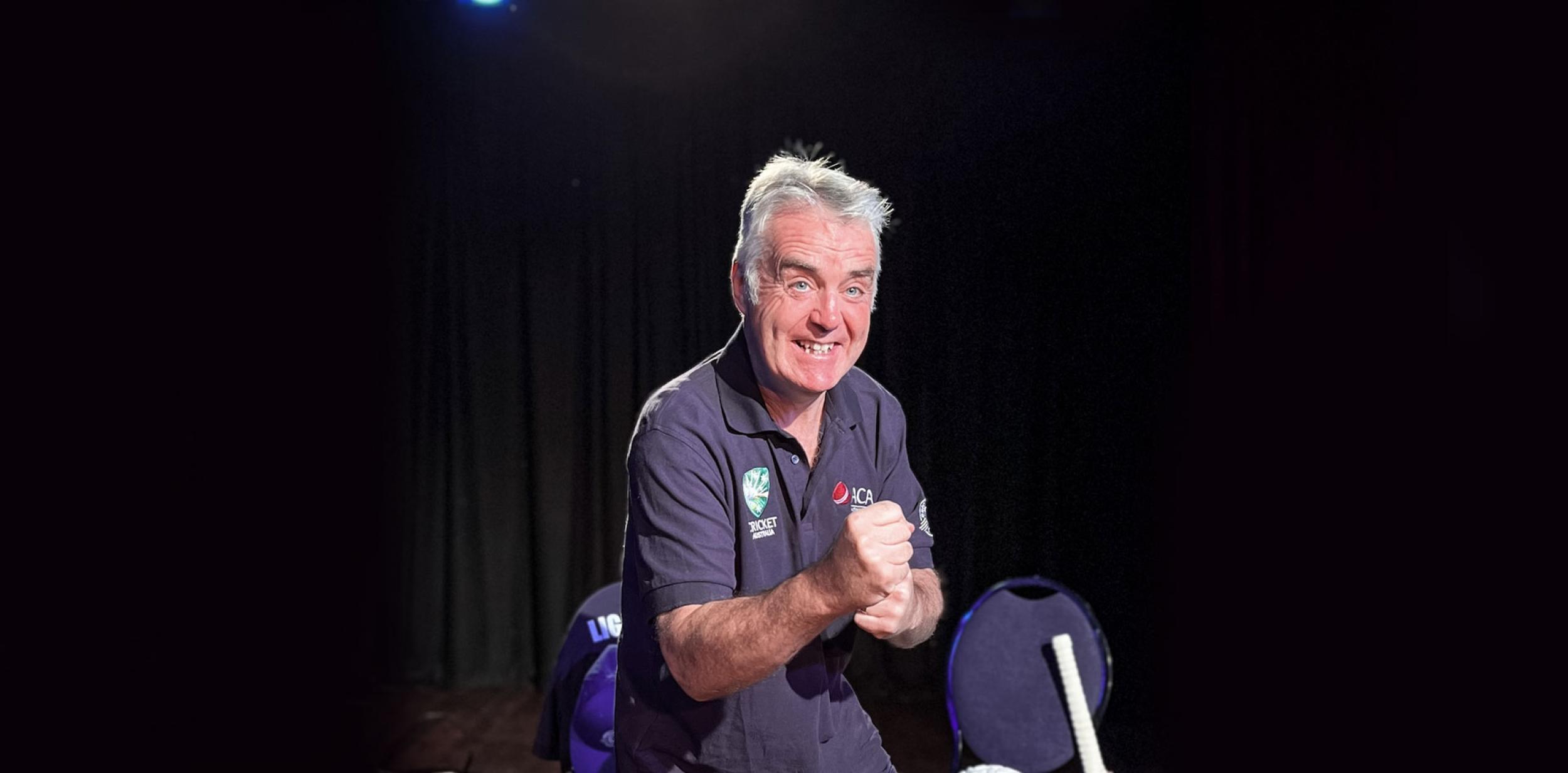 A person celebrating and wearing a cricket t-shirt