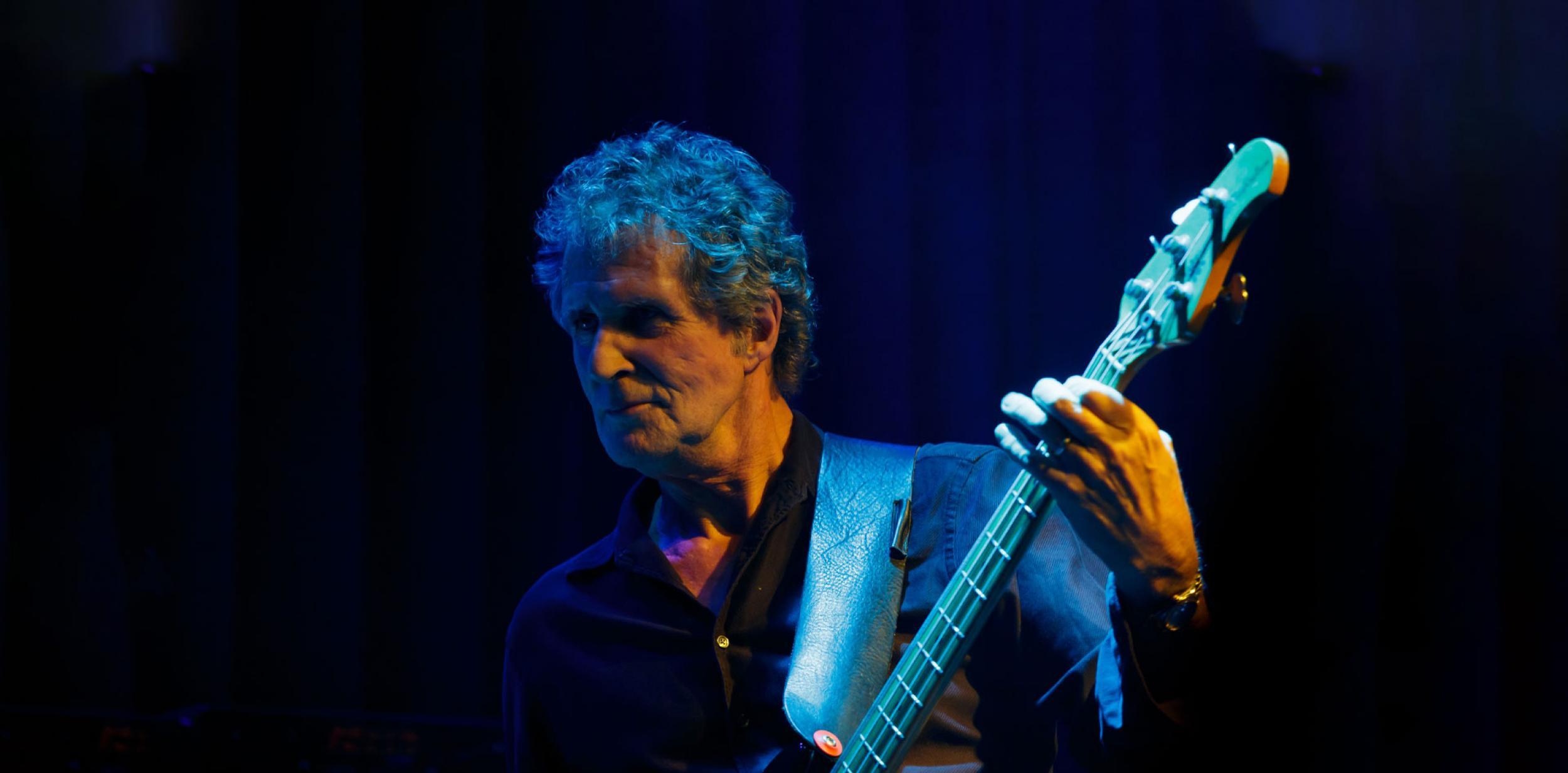 John Illsley playing guitar