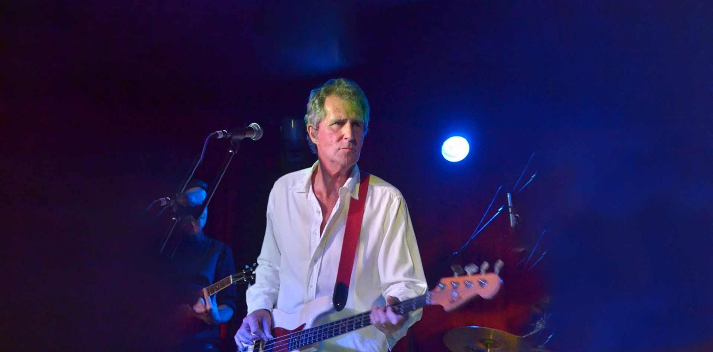 John Illsley playing guitar