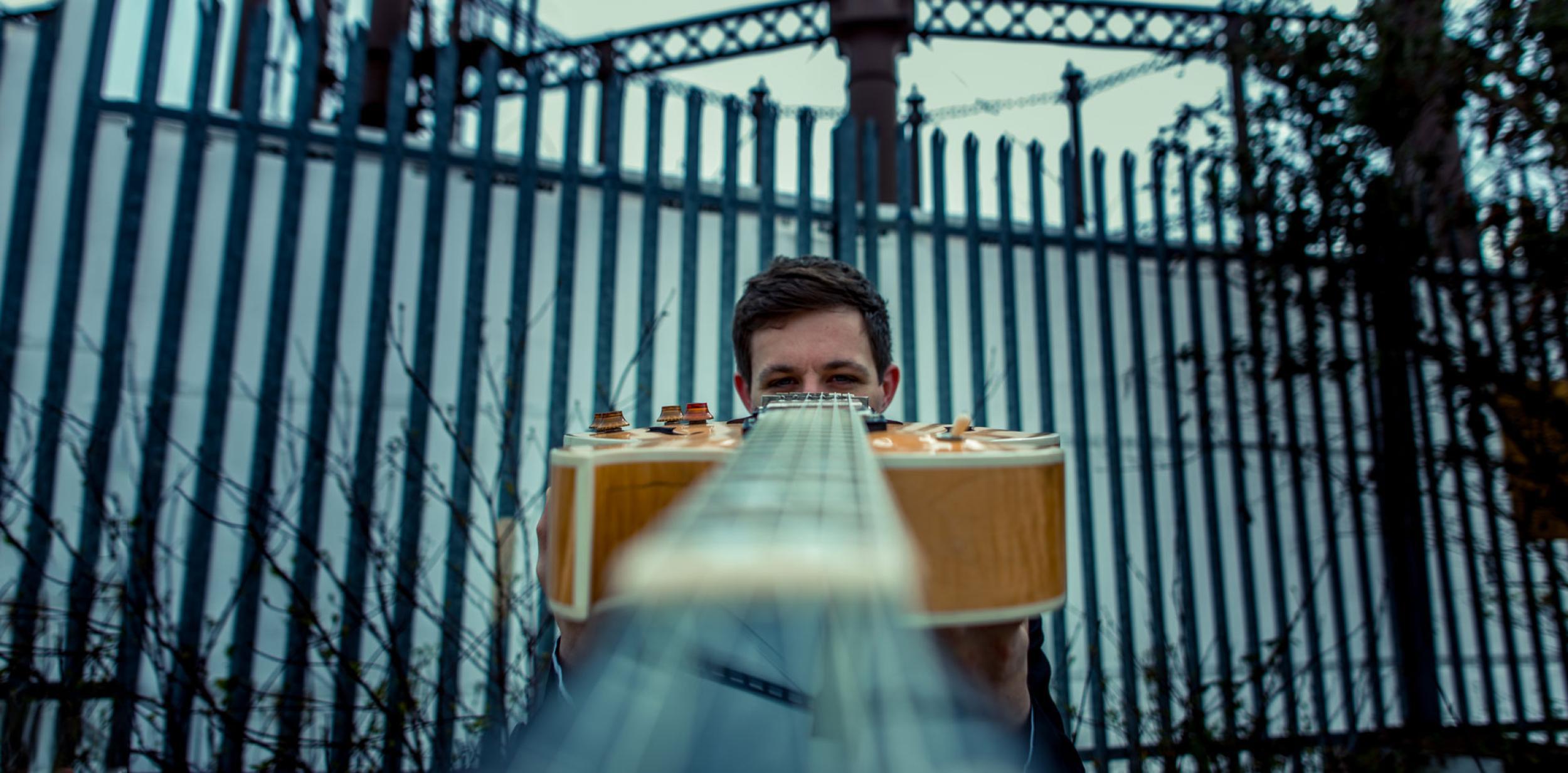 Leo Appleyard holding a guitar