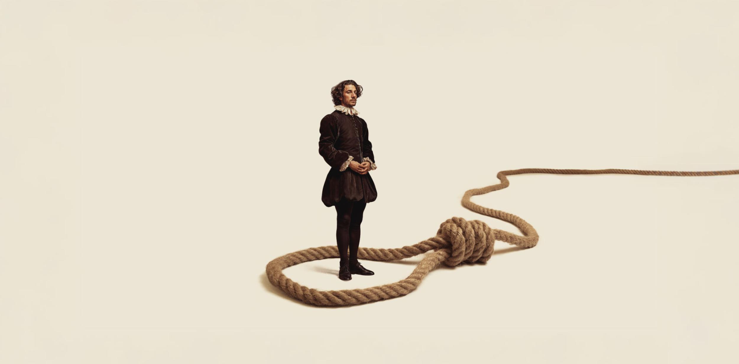 A person standing inside the noose of a giant rope