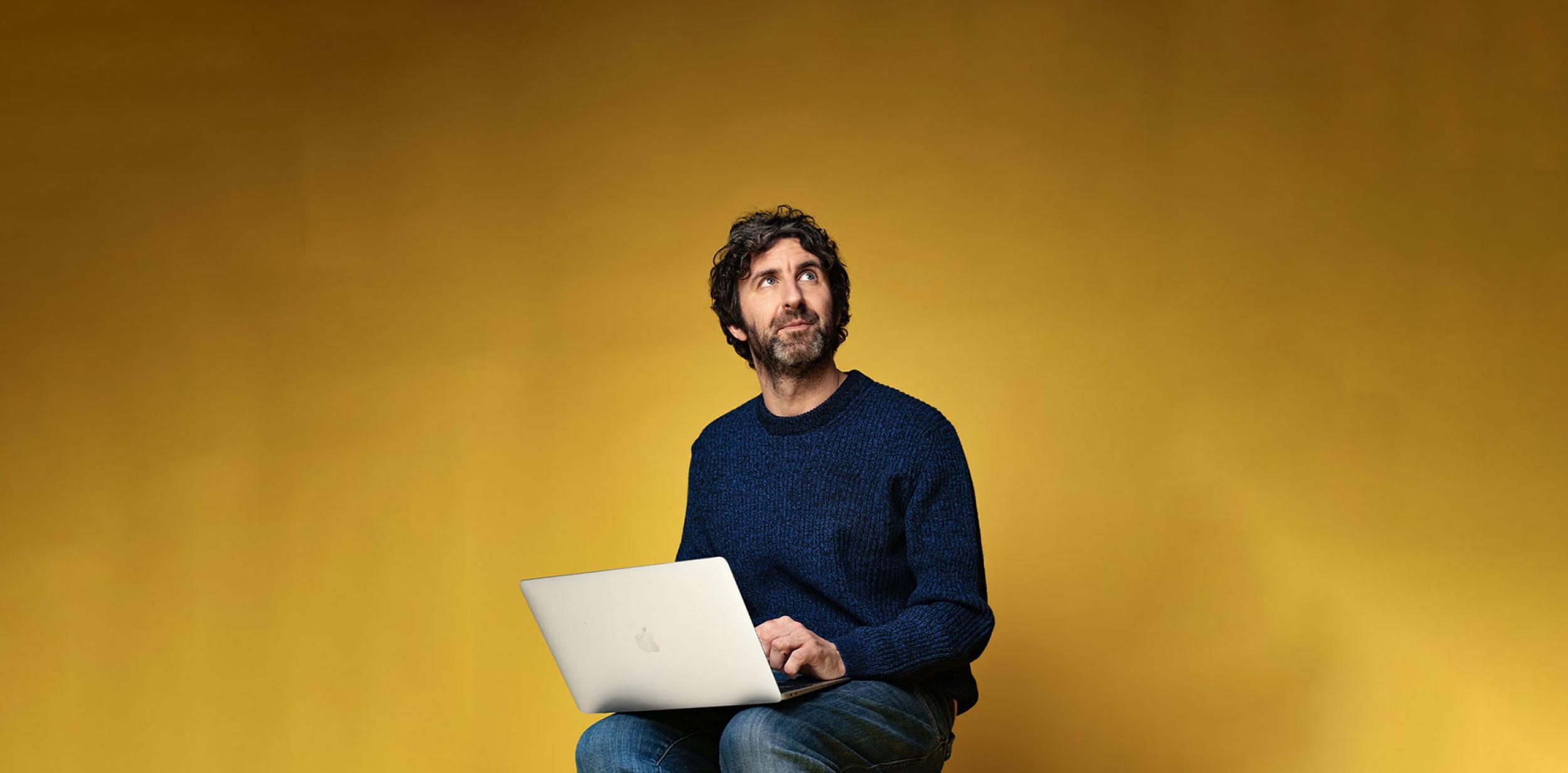 Mark Watson using a laptop