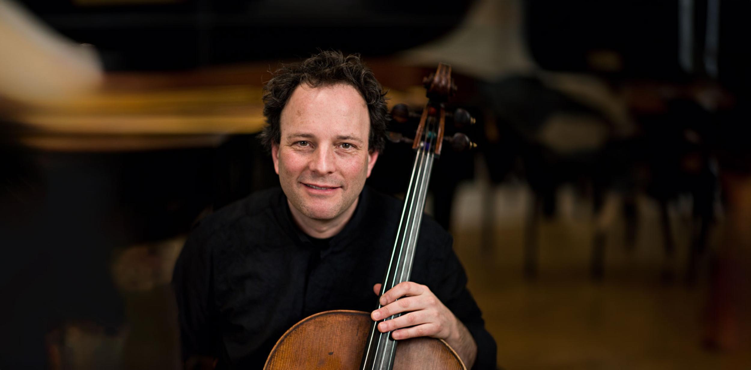 A person holding a large string instrument