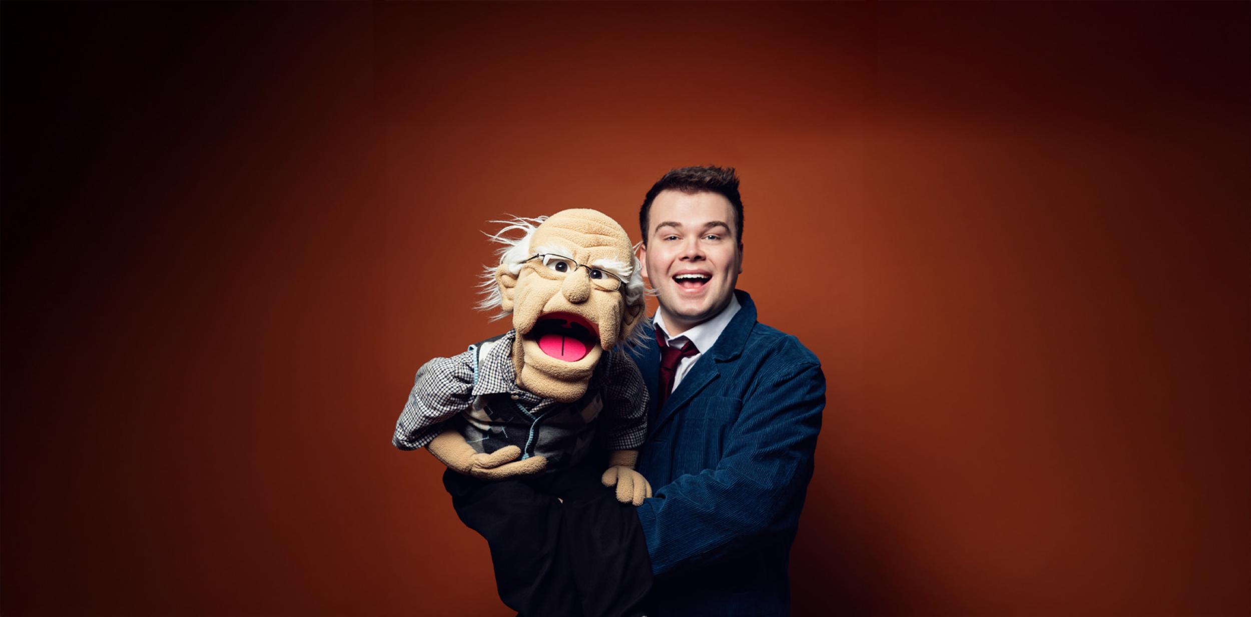 Max with an elderly man puppet on a red background