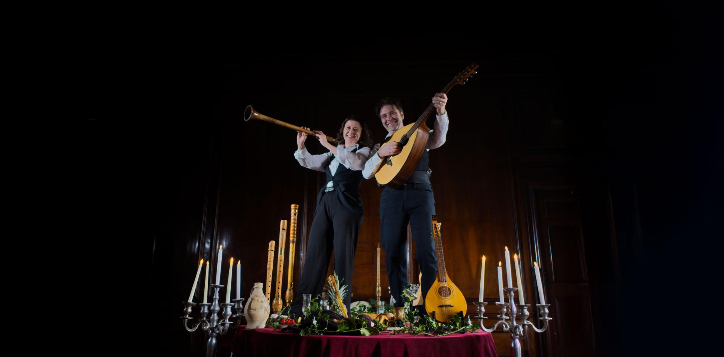 Two musicians standing on a large banquet table