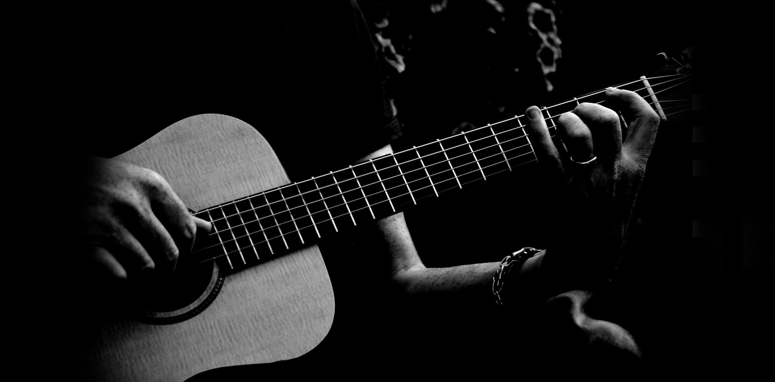 Close up of a person playing the guitar.