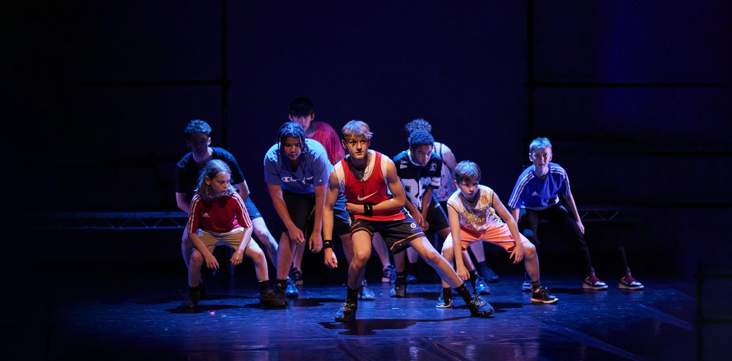 A group of young people dancing on a stage