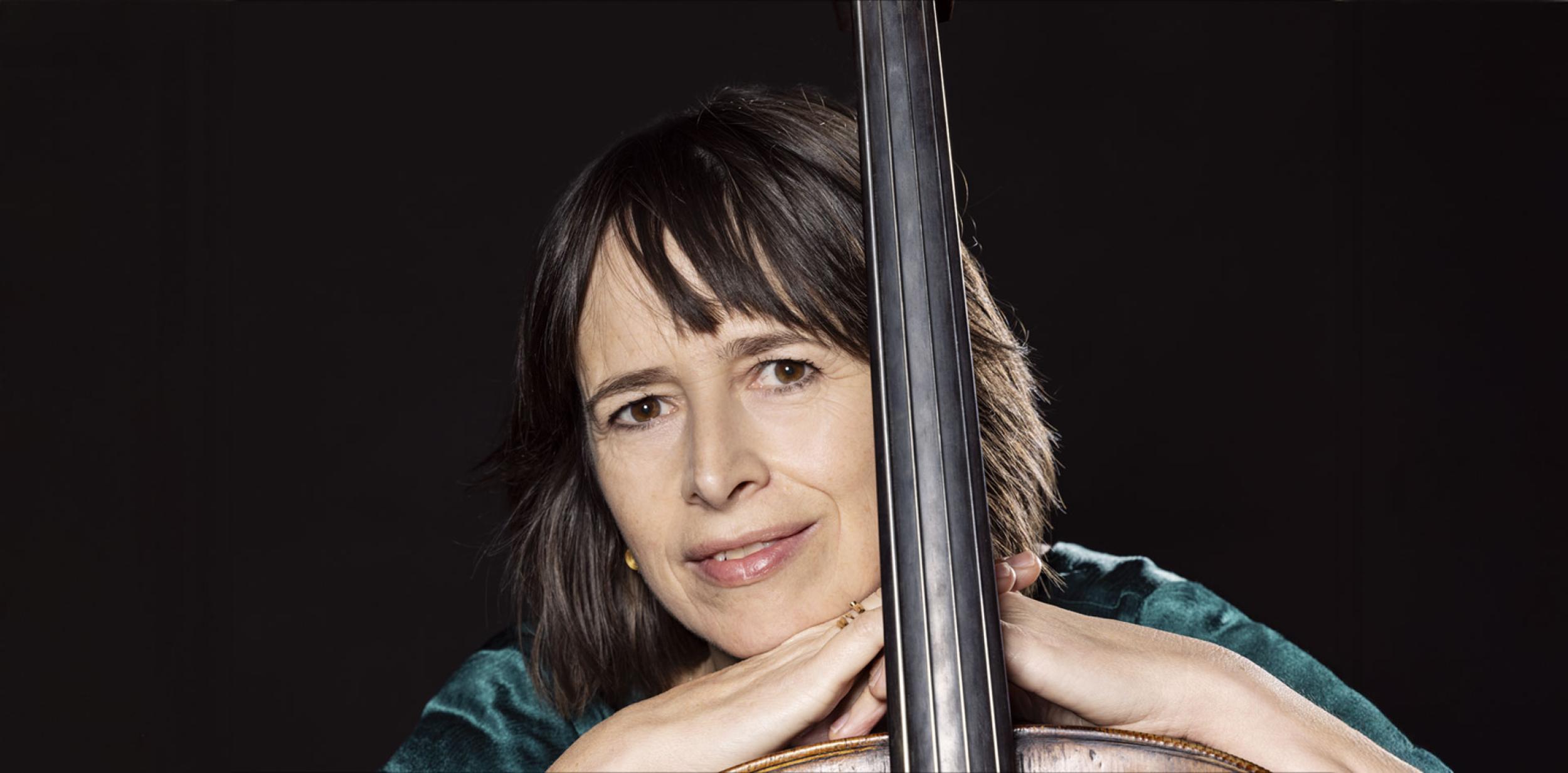 A person leaning against a musical instrument