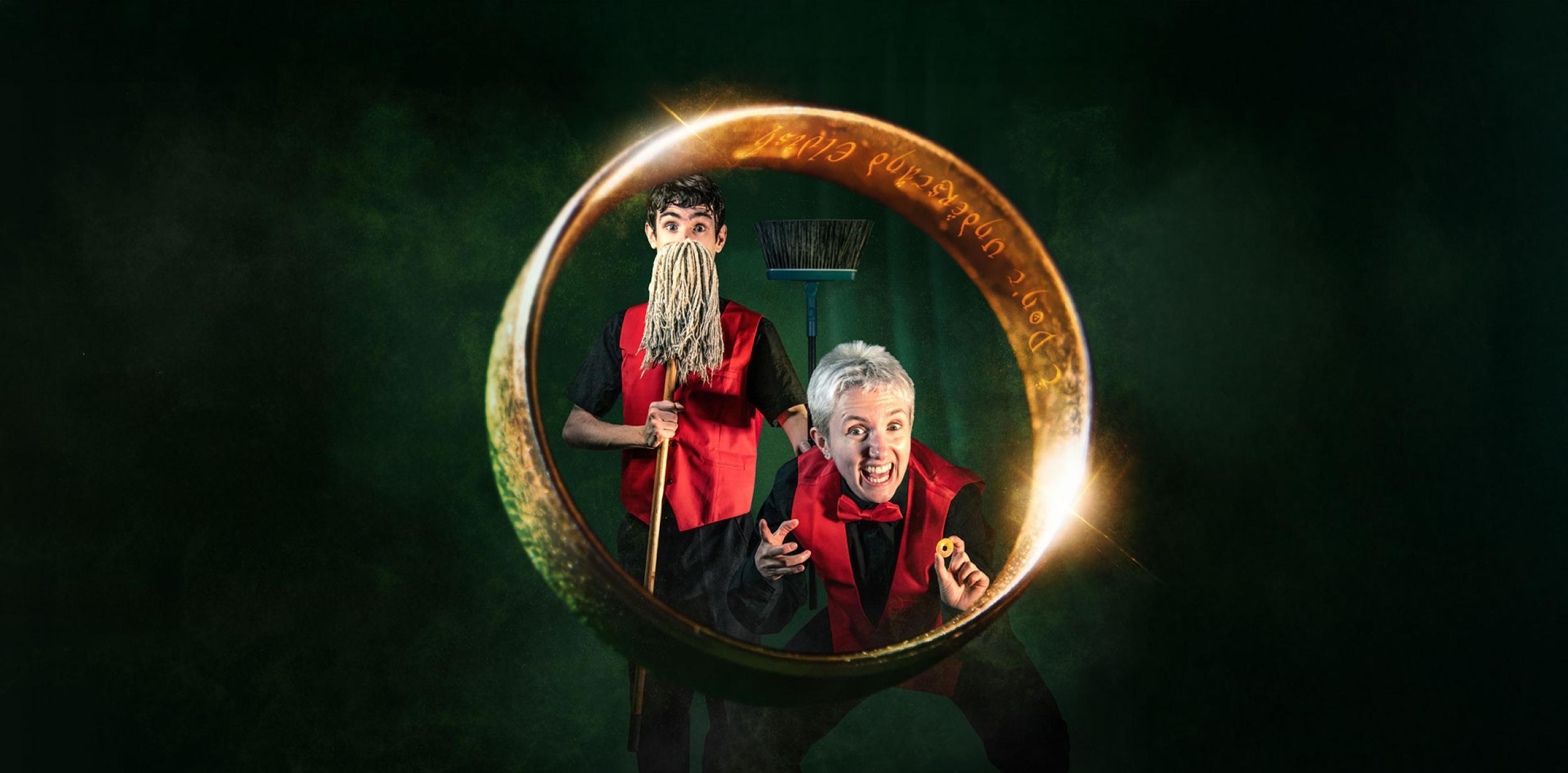 Two people surrounded by a large gold ring. One person is holding a mop.