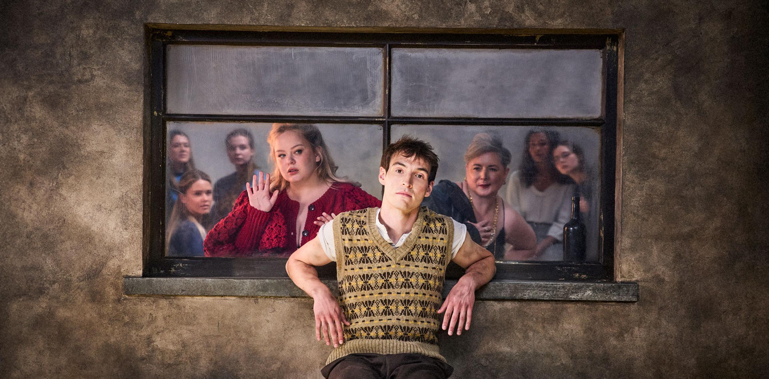 A person leaning against a window whilst people stare at them from the other side