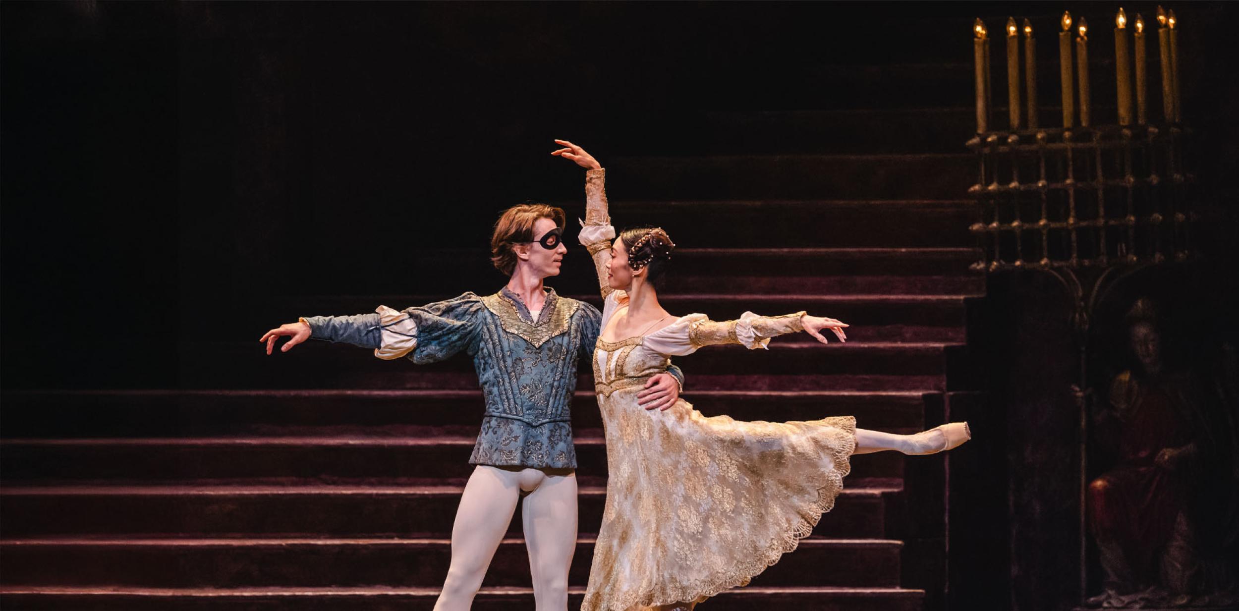 Romeo and Juliet dancing in masks.