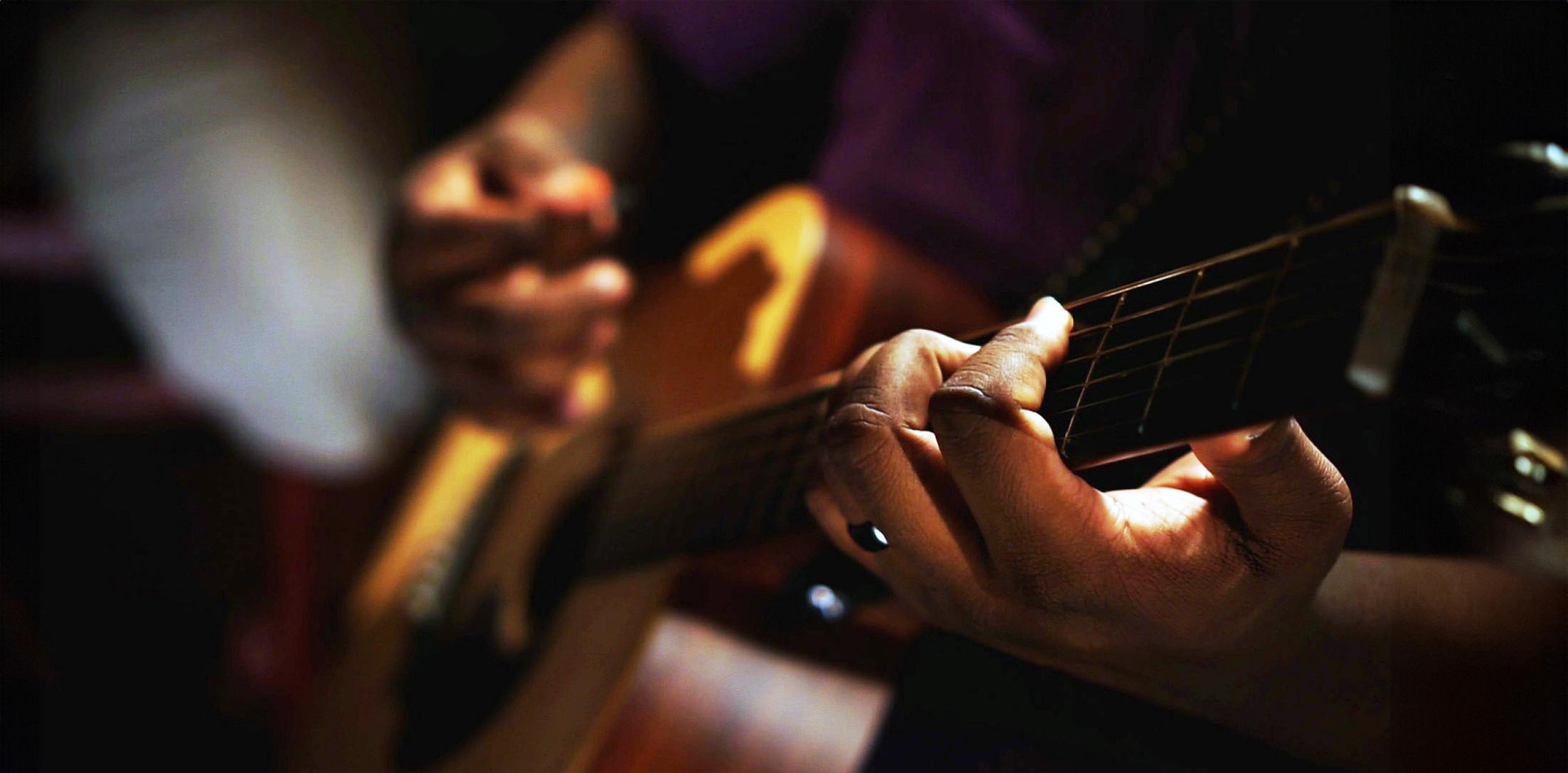 Closeup of someone playing an acoustic guitar