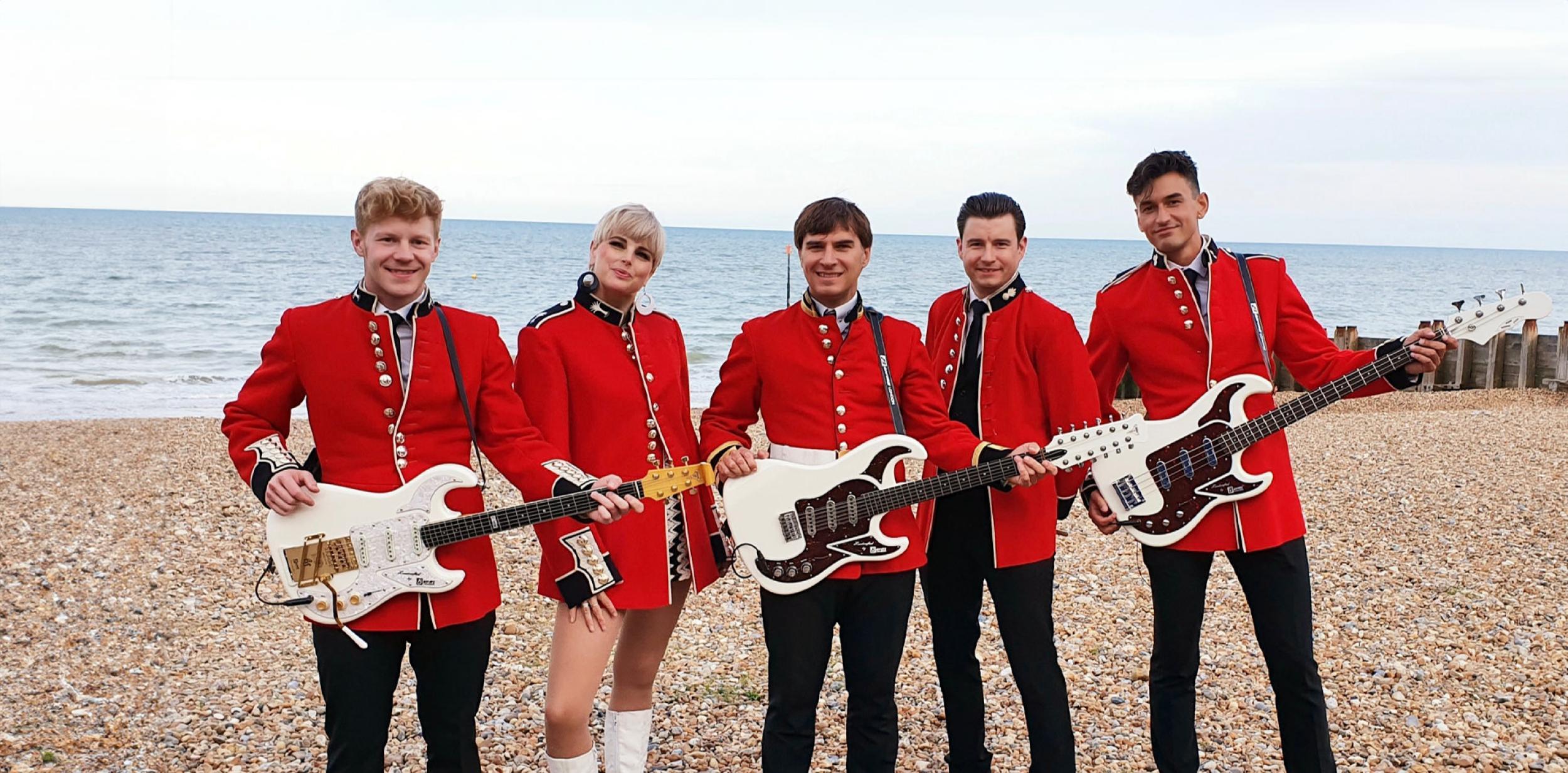 A band standing on a beach