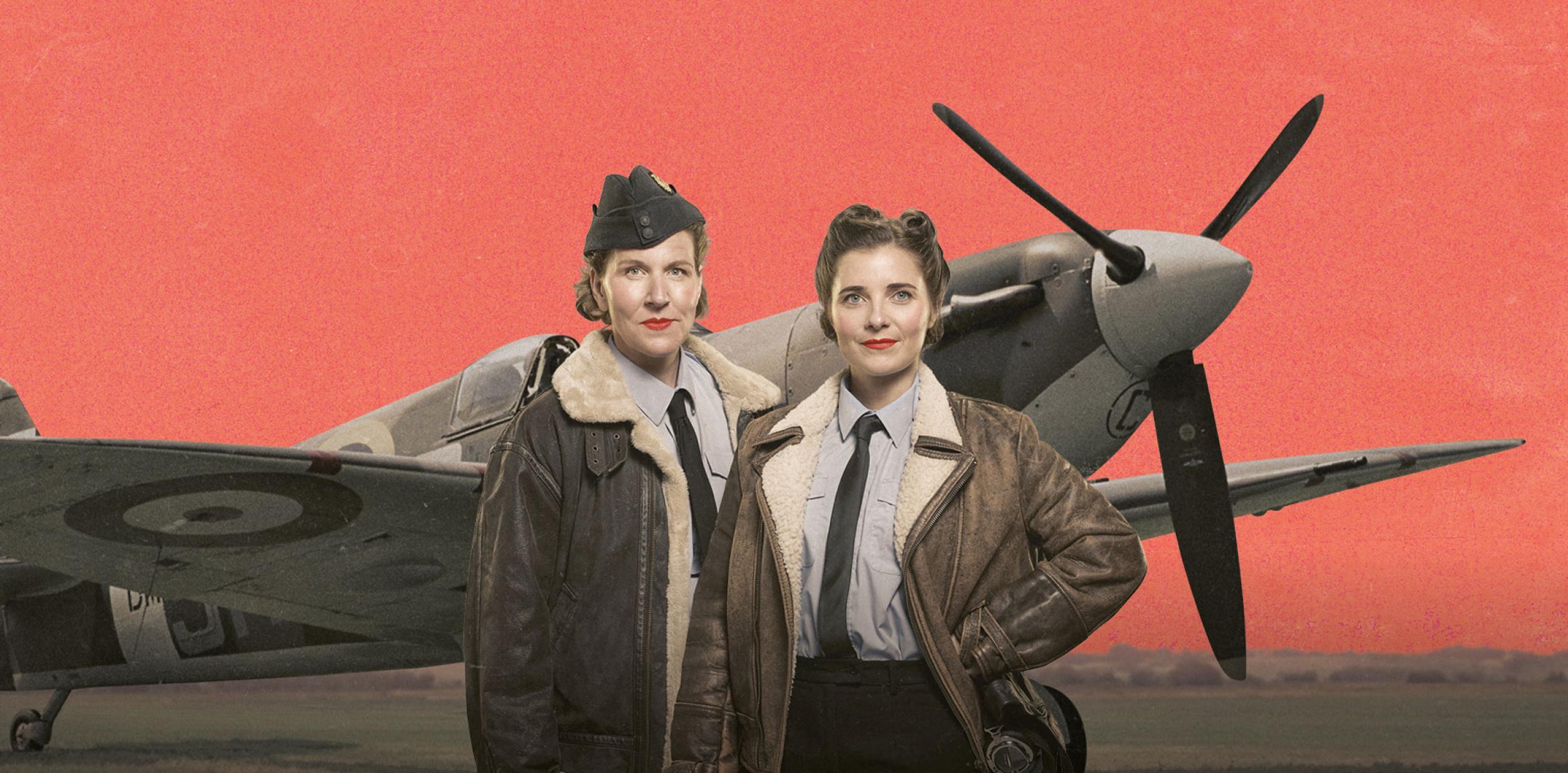 Two spitfire pilots standing in front of a spitfire plane
