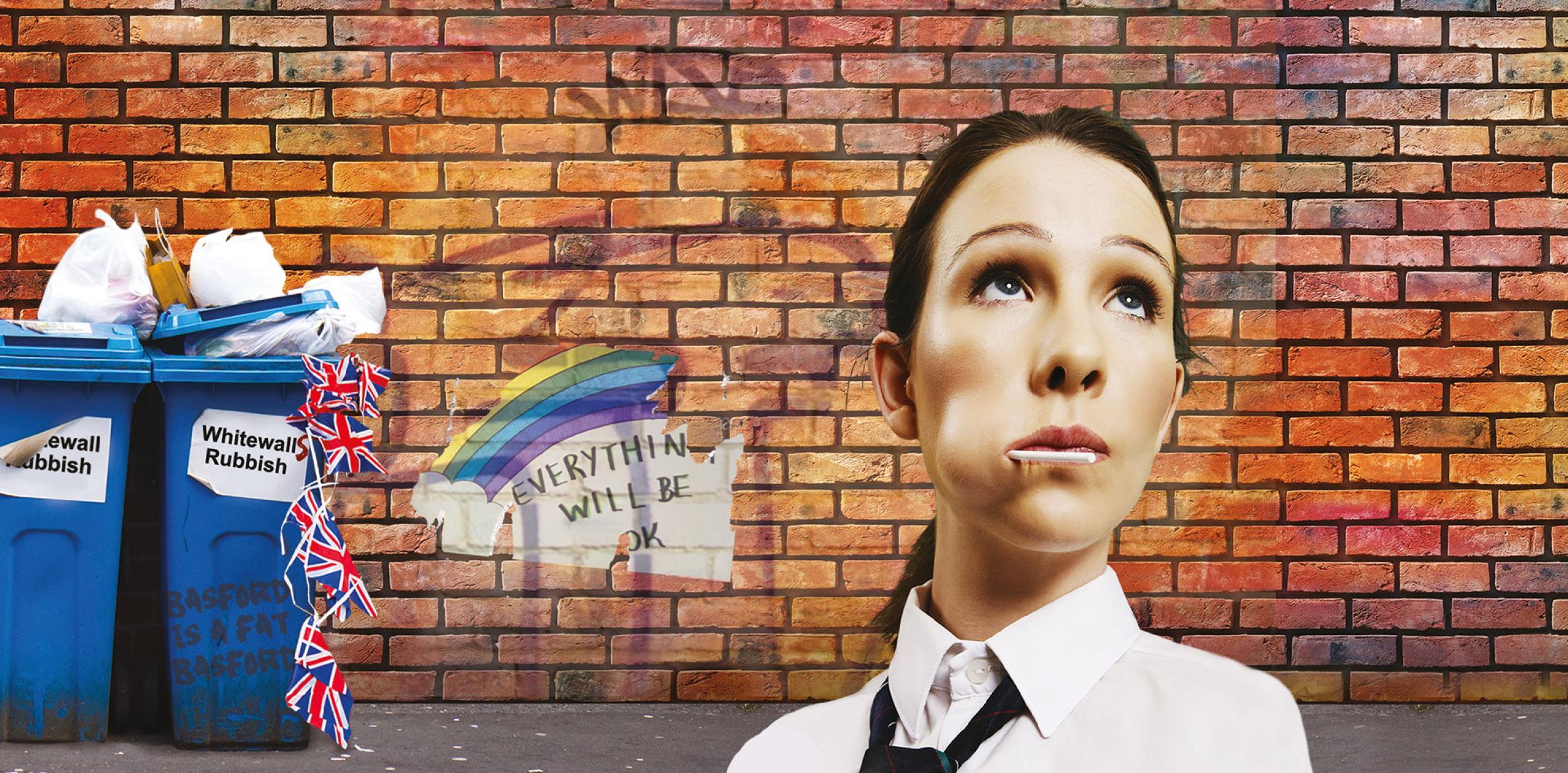 School girl standing by a brick wall