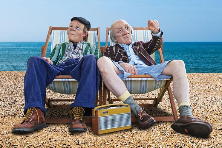 Two people on deckchairs at the beach