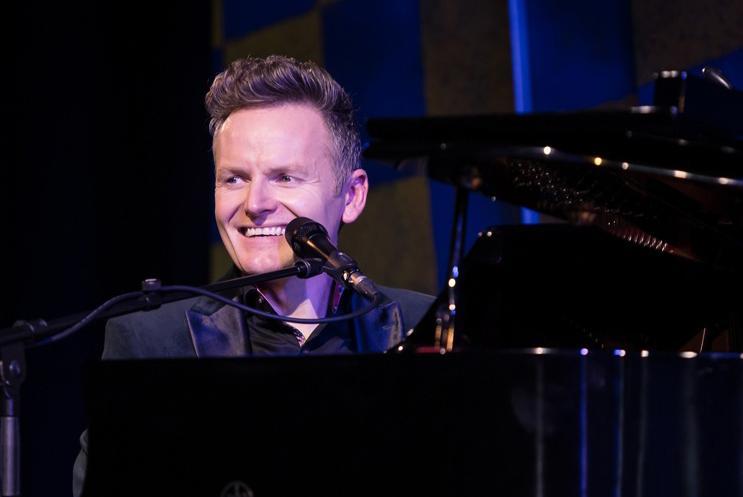 Joe Stilgoe sat at piano with microphone