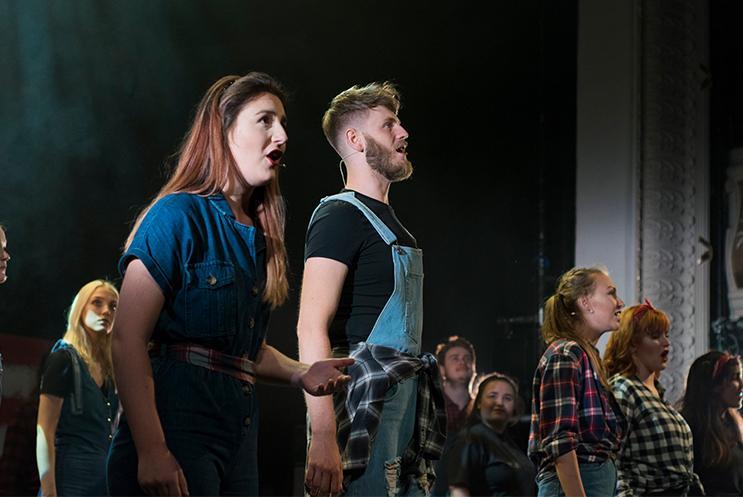 University students singing and performing