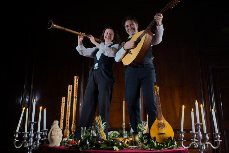 Two musicians standing on a large banquet table