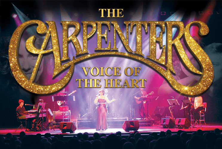 The Carpenters big title above a stage