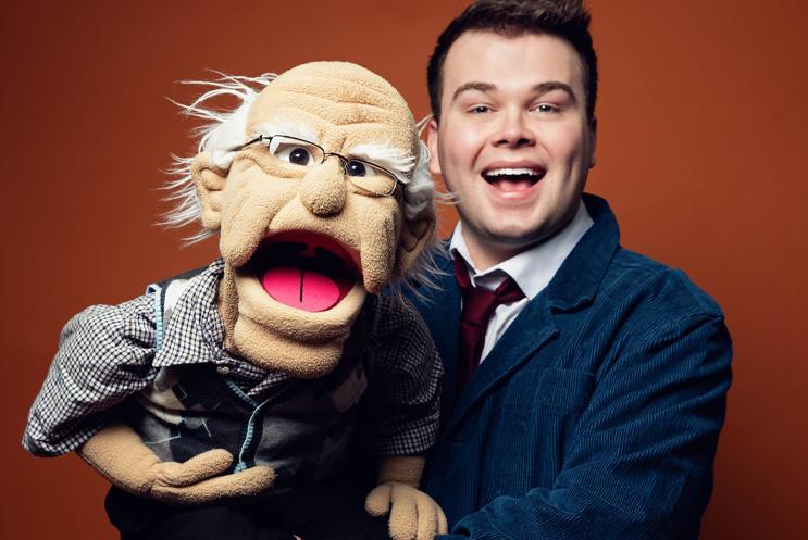 Max with an elderly man puppet on a red background