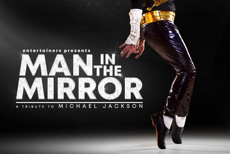 Text: Man in the Mirror and spotlight on "Michael Jackson's" leg in his classic dance move