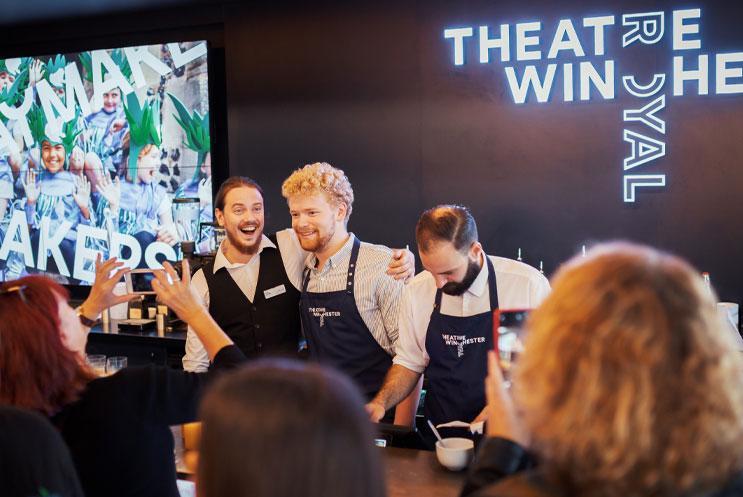 Team behind the bar, smiling