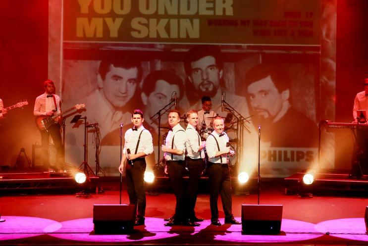 Four male singers on stage