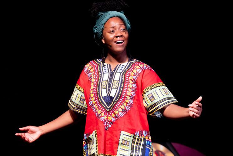 Performer with arms out looking happy