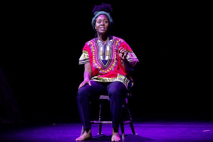 Performer sat it a chair singing