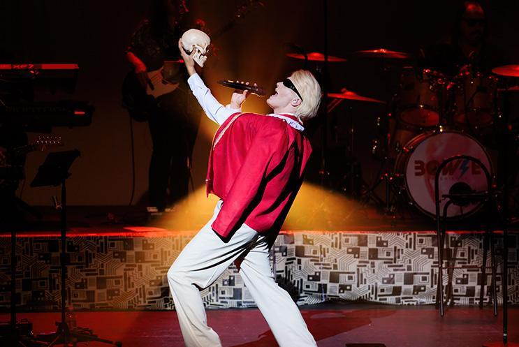 Bowie in red jacket holding skull