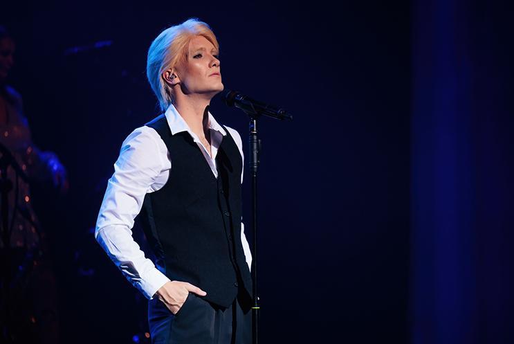 Bowie blonde in black vest and white shirt