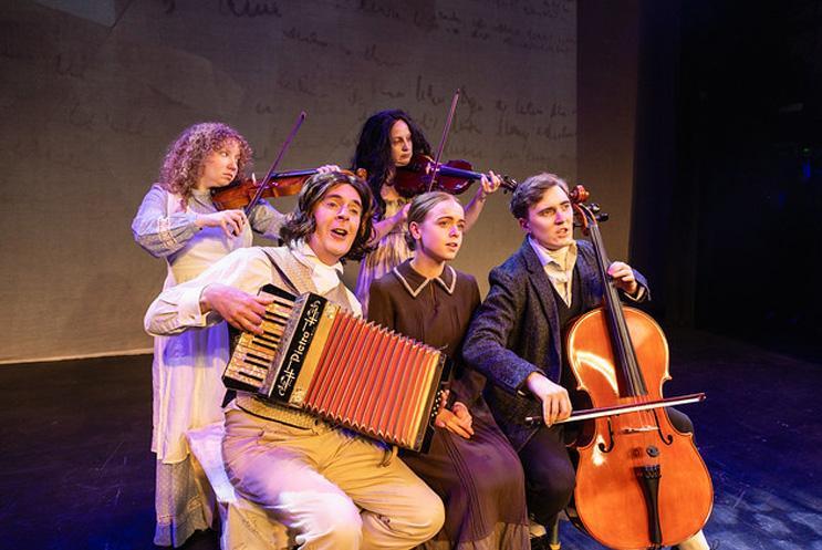 A group of performers singing and some playing musical instruments.