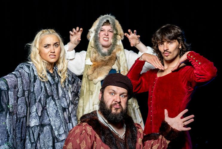 A group of people in period costume looking at the camera