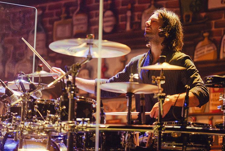 A musician playing the drums.