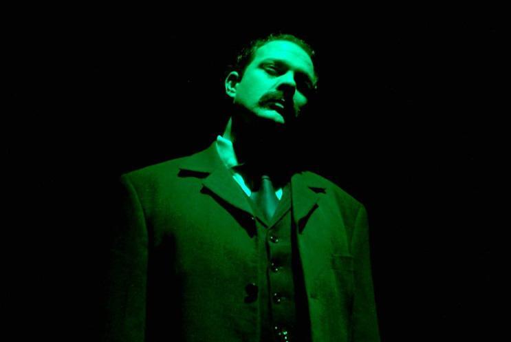 A Victorian man illuminated in green light