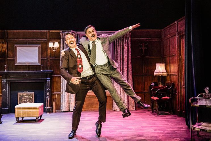 Two men dancing, with one lifting the other