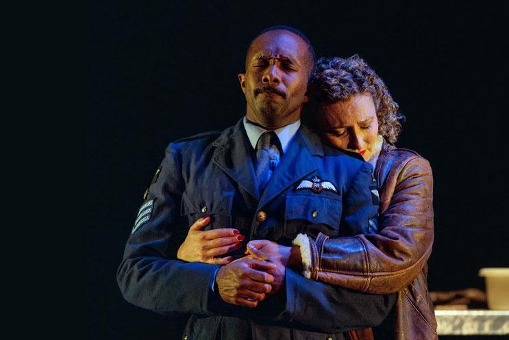 A woman embracing a man in a pilots uniform