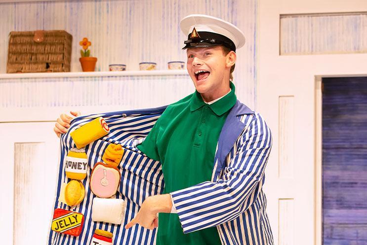 A man with food items inside his jacket